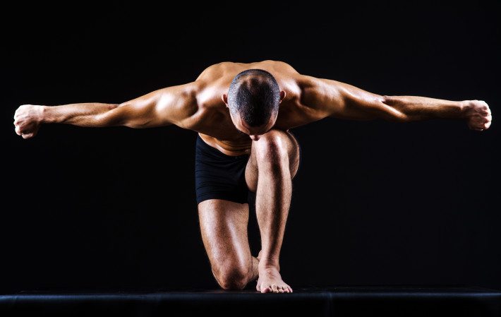 Muscular man in dark studio